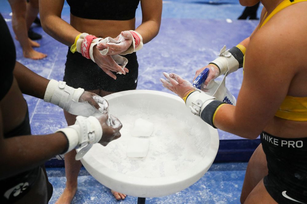 Iowa Hawkeyes chalk their hands before performing on bars during the Iowa women’s gymnastics Black and Gold Intraquad Meet on Saturday, December 7, 2019 at the UI Field House. (Lily Smith/hawkeyesports.com)