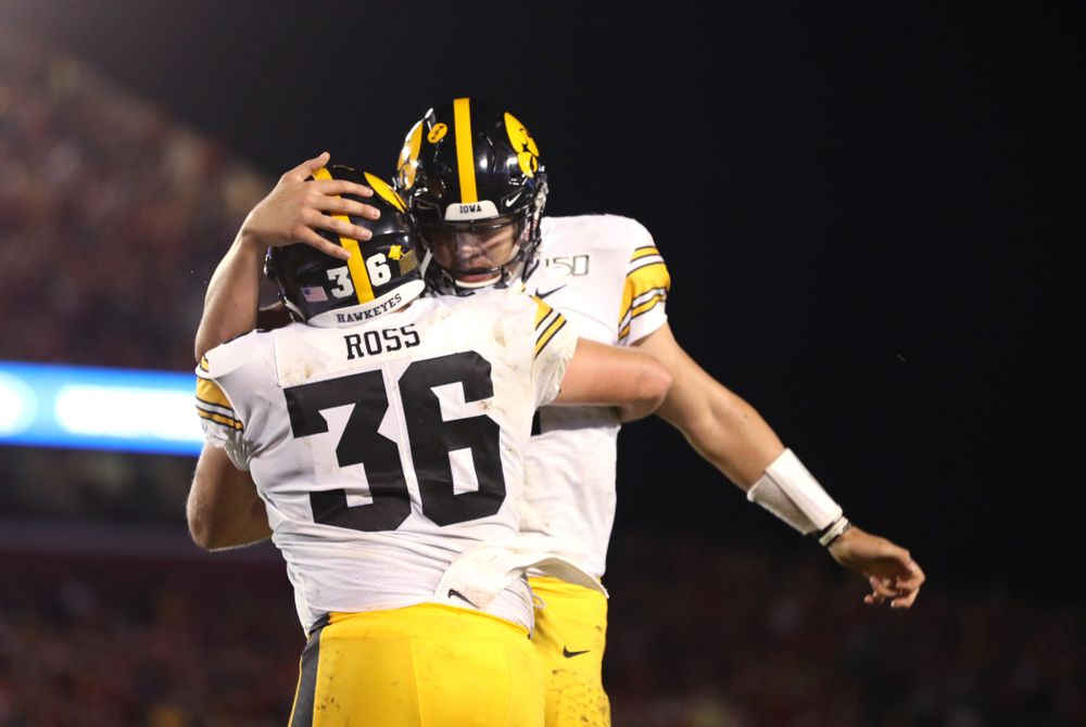 Iowa Hawkeyes quarterback Nate Stanley (4) celebrates with fullback Brady Ross (36) after scoring  against the Iowa State Cyclones Saturday, September 14, 2019 in Ames, Iowa. (Brian Ray/hawkeyesports.com)