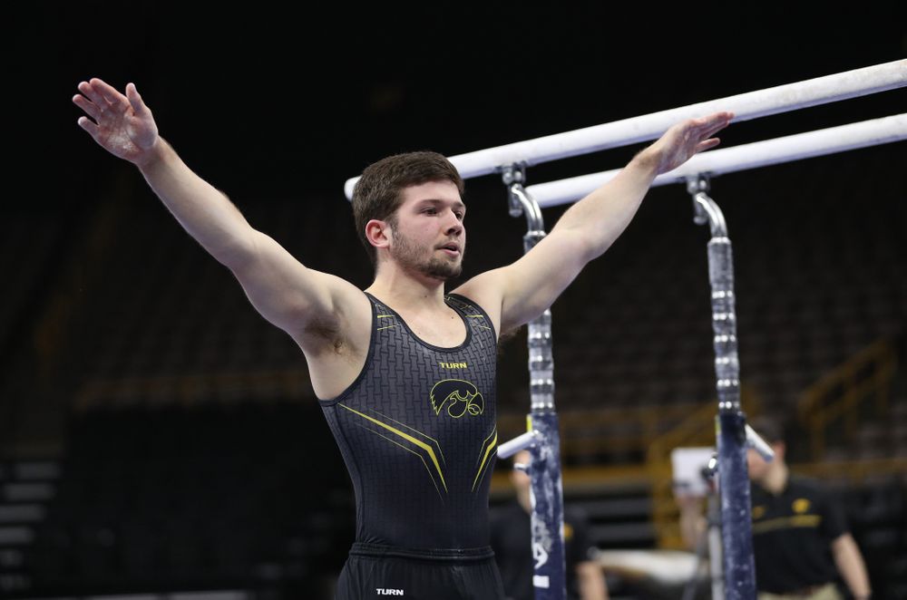 Iowa's Rogelio Vazquez competes on the parallel bars against the Ohio State Buckeyes  Saturday, March 16, 2019 at Carver-Hawkeye Arena.  (Brian Ray/hawkeyesports.com)