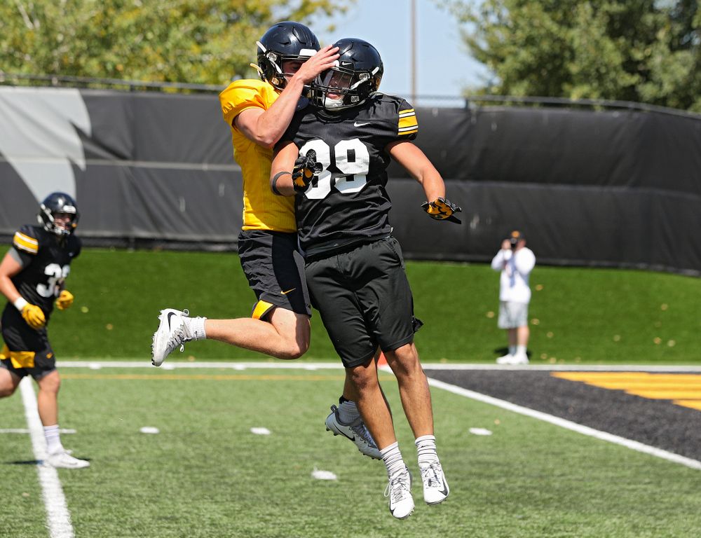 Iowa Hawkeyes quarterback Peyton Mansell (2) celebrates with wide receiver Nico Ragaini (89) after throwing him a touchdown pass during Fall Camp Practice No. 7 at the Hansen Football Performance Center in Iowa City on Friday, Aug 9, 2019. (Stephen Mally/hawkeyesports.com)