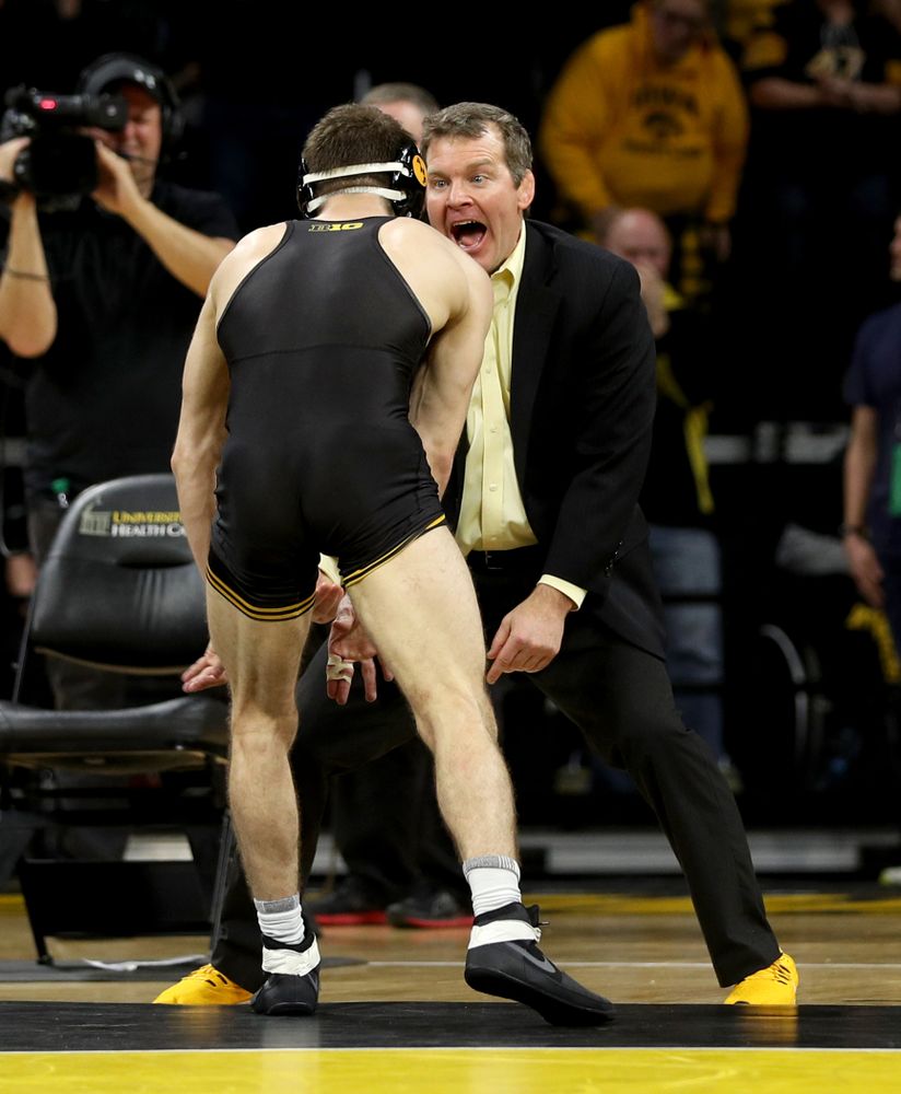 Iowa head coach Tom Brands celebrates with Austin DeSanto after his match against Ohio State’s Jordan Decatur at 133 pounds Friday, January 24, 2020 at Carver-Hawkeye Arena. DeSanto won the match with a 21-3 tech fall. (Brian Ray/hawkeyesports.com)