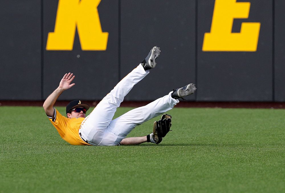 Iowa Hawkeyes right fielder Luke Farley (8) hangs onto the ball as he makes a diving catch for an out during the third inning of their game against Northern Illinois at Duane Banks Field in Iowa City on Tuesday, Apr. 16, 2019. (Stephen Mally/hawkeyesports.com)