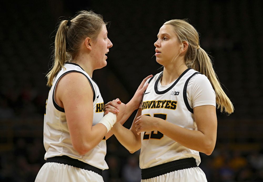 Iowa forward/center Monika Czinano (25) talks with forward Logan Cook (23) during the third quarter of their overtime win against Princeton at Carver-Hawkeye Arena in Iowa City on Wednesday, Nov 20, 2019. (Stephen Mally/hawkeyesports.com)
