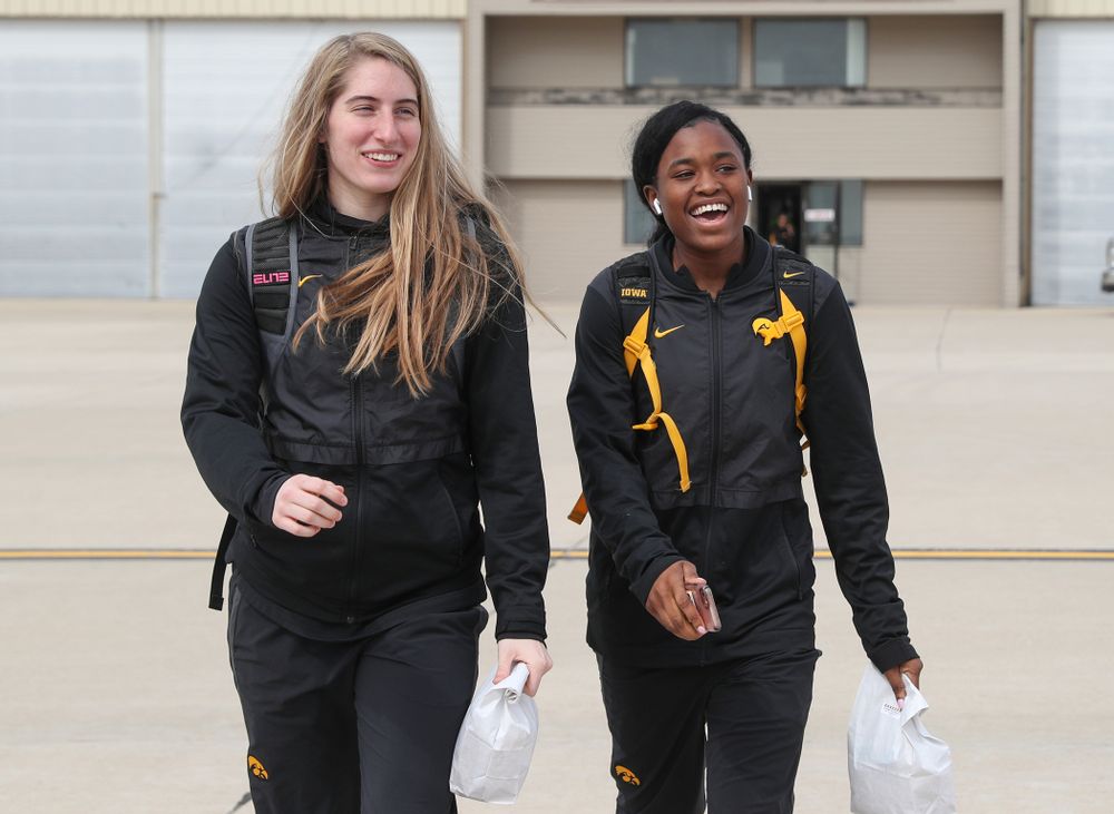 Iowa Hawkeyes guard Kate Martin (20) and guard Tomi Taiwo (1) board the team plane to Greensboro, NC for the Regionals of the 2019 NCAA Women's Basketball Championships Thursday, March 28, 2019 at the Eastern Iowa Airport. (Brian Ray/hawkeyesports.com)