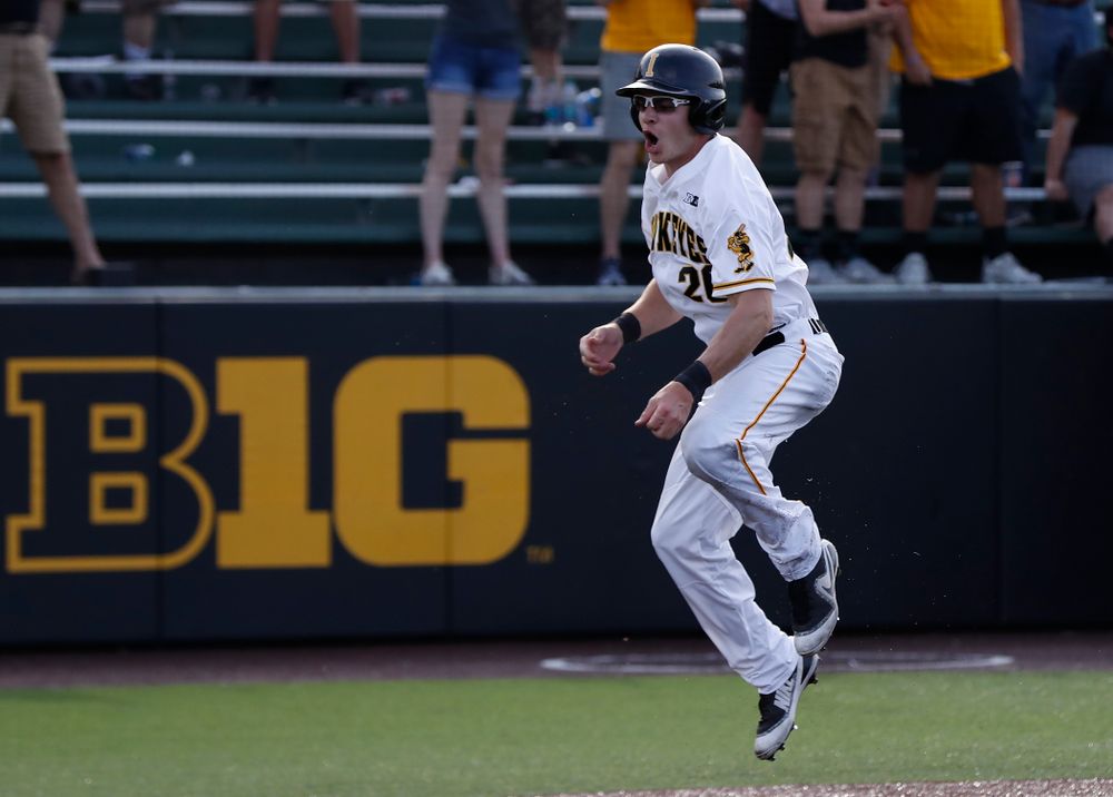 Iowa Hawkeyes catcher Austin Guzzo (20) celebrates after scoring against the Oklahoma State Cowboys Saturday, May 5, 2018 at Duane Banks Field. (Brian Ray/hawkeyesports.com)