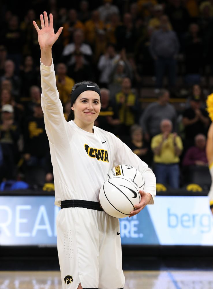 Iowa Hawkeyes forward Megan Gustafson (10) receives a pair of commemorative basketballs from head coach Lisa Bluder for becoming the school's all time rebounds leader and scoring leader before their gam eagainst the Nebraska Cornhuskers Thursday, January 3, 2019 at Carver-Hawkeye Arena. (Brian Ray/hawkeyesports.com)
