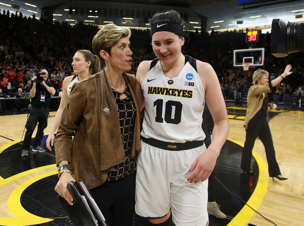 Iowa Hawkeyes associate head coach Jan Jensen and forward Megan Gustafson (10) talk as they walk off the court after winning their game during the first round of the 2019 NCAA Women's Basketball Tournament at Carver Hawkeye Arena in Iowa City on Friday, Mar. 22, 2019. (Stephen Mally for hawkeyesports.com)