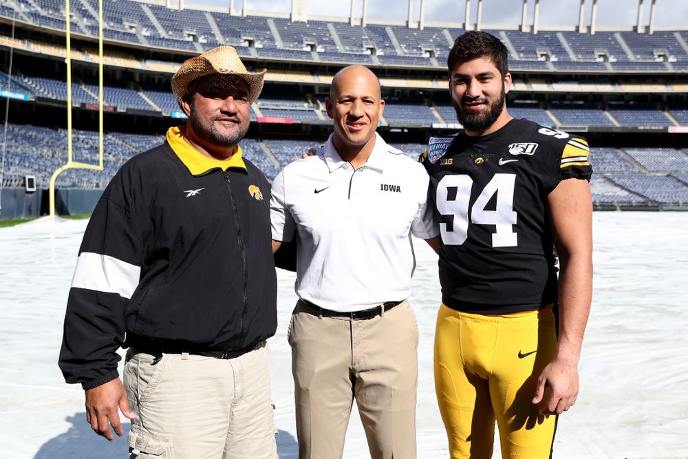 Eppy Epenesa, Iowa Hawkeyes special teams coordinator LeVar Woods, and defensive end A.J. Epenesa (94) following the team photo Wednesday, December 25, 2019 at SDCCU Stadium in San Diego. (Brian Ray/hawkeyesports.com)