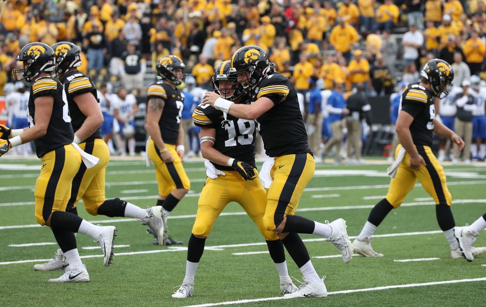 Iowa Hawkeyes quarterback Spencer Petras (7) hugs wide receiver Max Cooper (19) after scoring gainst Middle Tennessee State Saturday, September 28, 2019 at Kinnick Stadium. (Brian Ray/hawkeyesports.com)