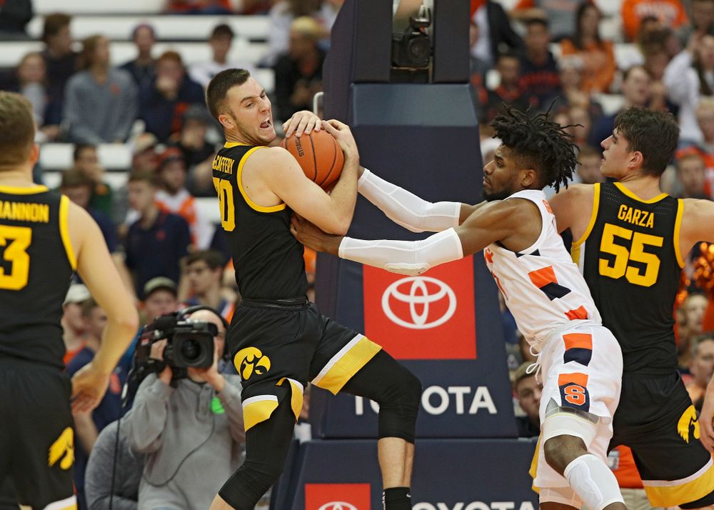 Iowa Hawkeyes guard Connor McCaffery (30) pulls down a rebound during the second half of their ACC/Big Ten Challenge game at the Carrier Dome in Syracuse, N.Y. on Tuesday, Dec 3, 2019. (Stephen Mally/hawkeyesports.com)