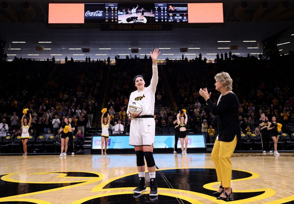 Iowa Hawkeyes forward Megan Gustafson (10) revives a ball commemorating her 1,00th career rebound from Iowa Hawkeyes head coach Lisa Bluder during their game against the IUPUI Jaguars Saturday, December 8, 2018 at Carver-Hawkeye Arena. (Brian Ray/hawkeyesports.com)