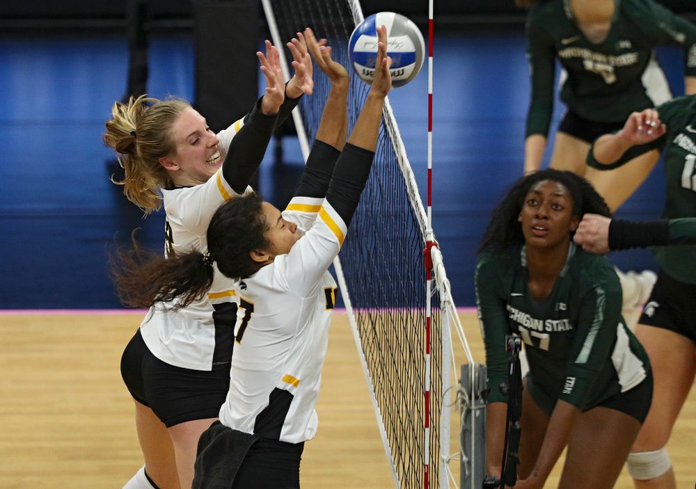 Iowa’s Hannah Clayton (18) and Brie Orr (7) block a shot during the third set of their volleyball match at Carver-Hawkeye Arena in Iowa City on Sunday, Oct 13, 2019. (Stephen Mally/hawkeyesports.com)