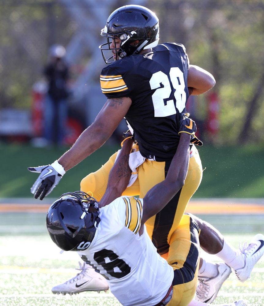 Iowa Hawkeyes running back Toren Young (28) and defensive back Terry Roberts (16) during the teamÕs final spring practice Friday, April 26, 2019 at the Kenyon Football Practice Facility. (Brian Ray/hawkeyesports.com)
