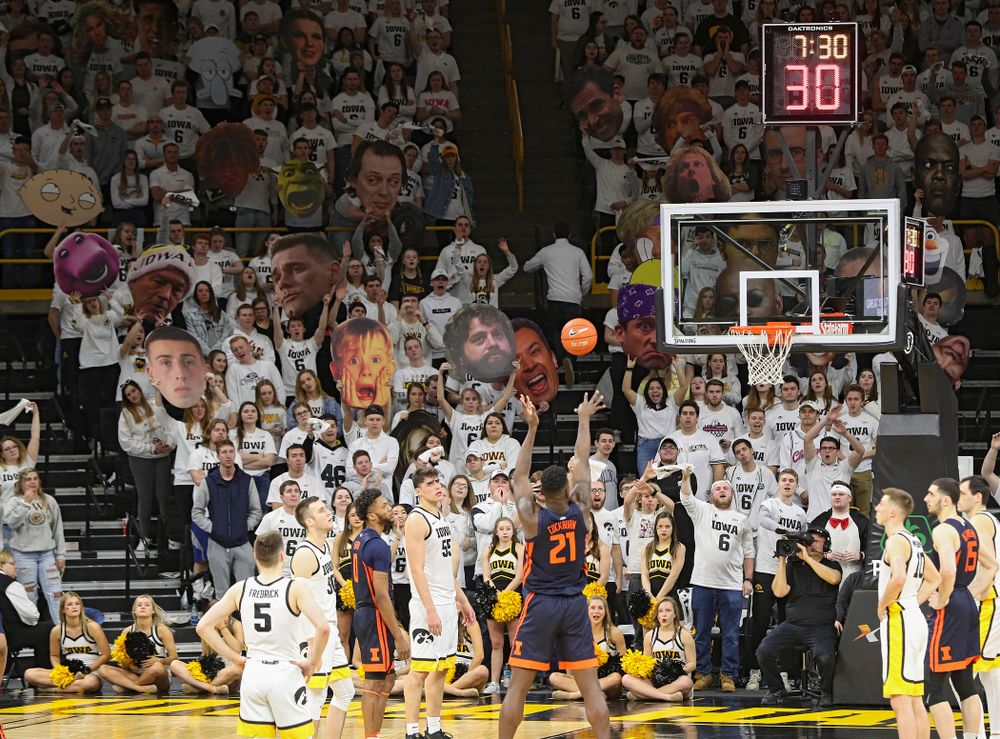 Students in the Hawks Nest hold up heads to distract an Illinois player shooting a free throw during the second half of the game at Carver-Hawkeye Arena in Iowa City on Sunday, February 2, 2020. (Stephen Mally/hawkeyesports.com)