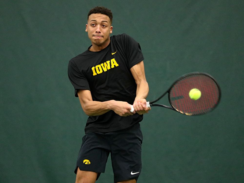 Iowa’s Oliver Okonkwo returns a shot during his singles match at the Hawkeye Tennis and Recreation Complex in Iowa City on Friday, February 14, 2020. (Stephen Mally/hawkeyesports.com)