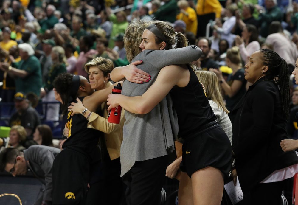 Iowa Hawkeyes forward Hannah Stewart (21) hugs head coach Lisa Bluder at the end of the regional final against the Baylor Lady Bears in the 2019 NCAA Women's College Basketball Tournament Monday, April 1, 2019 at Greensboro Coliseum in Greensboro, NC.(Brian Ray/hawkeyesports.com)