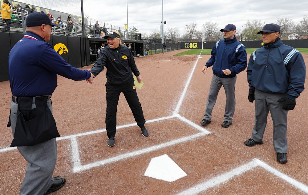 Iowa head coach Renee Gillispie greets the umpires before their game against Illinois at Pearl Field in Iowa City on Friday, Apr. 12, 2019. (Stephen Mally/hawkeyesports.com)