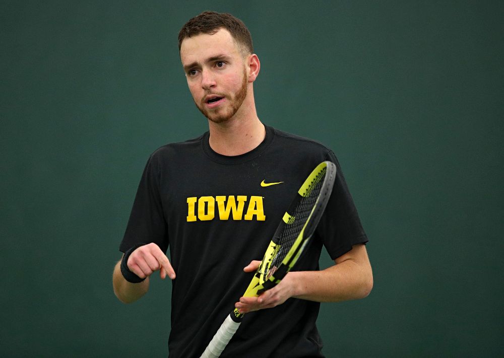 Iowa’s Kareem Allaf points to the court as he celebrates a point during his singles match at the Hawkeye Tennis and Recreation Complex in Iowa City on Friday, March 6, 2020. (Stephen Mally/hawkeyesports.com)