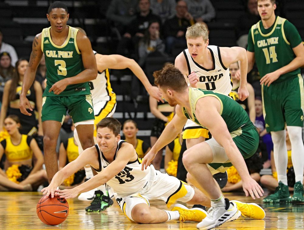 Iowa Hawkeyes guard Austin Ash (13) dives for a loose ball on the floor during the second half of their game at Carver-Hawkeye Arena in Iowa City on Sunday, Nov 24, 2019. (Stephen Mally/hawkeyesports.com)