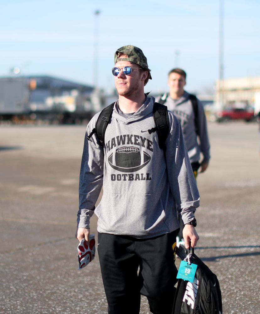 Iowa Hawkeyes wide receiver Max Cooper (19) boards the team plane at the Eastern Iowa Airport Saturday, December 21, 2019 on the way to San Diego, CA for the Holiday Bowl. (Brian Ray/hawkeyesports.com)