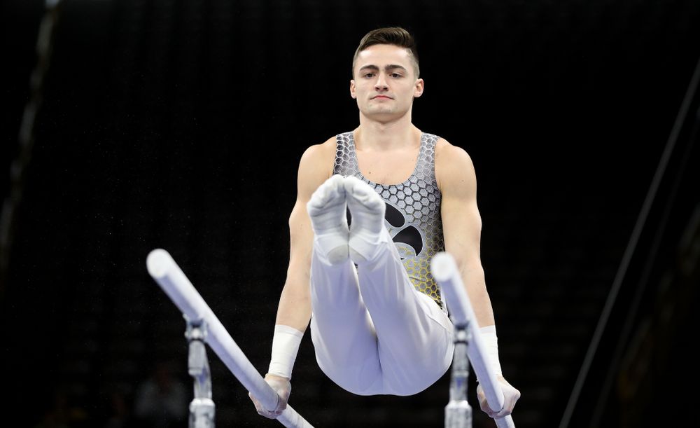 Iowa’s Mitch Mandozzi competes on the parallel bars against Illinois Sunday, March 1, 2020 at Carver-Hawkeye Arena. (Brian Ray/hawkeyesports.com)