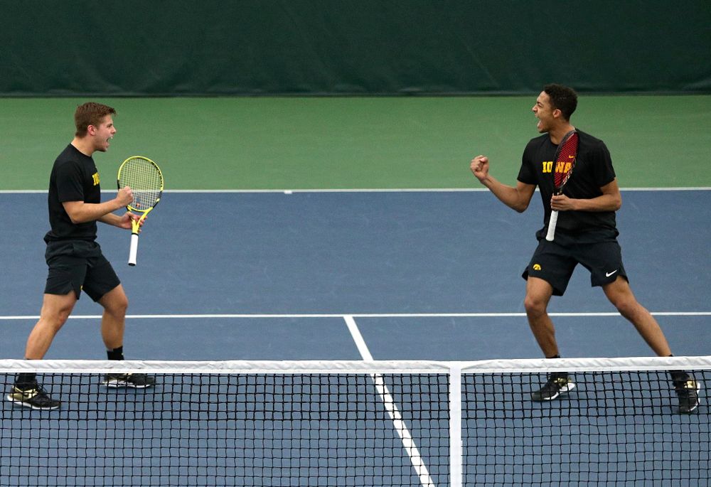 Iowa’s Will Davies (from left) and Oliver Okonkwo celebrate a point during their doubles match at the Hawkeye Tennis and Recreation Complex in Iowa City on Friday, March 6, 2020. (Stephen Mally/hawkeyesports.com)