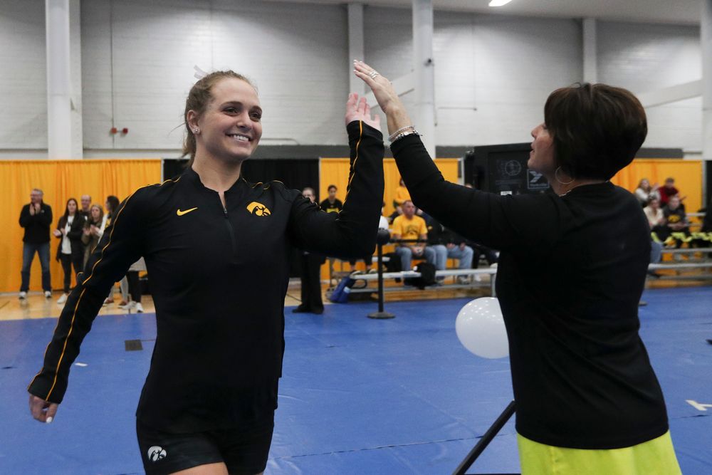 Ashley Smith high fives assistant coach Jennifer Green before the Iowa women’s gymnastics Black and Gold Intraquad Meet on Saturday, December 7, 2019 at the UI Field House. (Lily Smith/hawkeyesports.com)