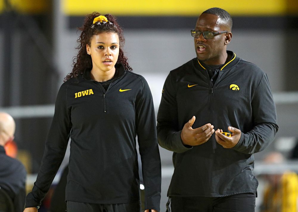 Iowa’s Dallyssa Huggins (from left) talks with associate head coach Clive Roberts during the Larry Wieczorek Invitational at the Recreation Building in Iowa City on Friday, January 17, 2020. (Stephen Mally/hawkeyesports.com)
