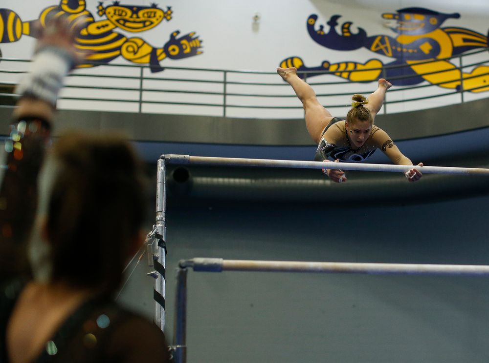 Emma Hartzler competes on the uneven bars during the Black and Gold Intrasquad meet at the Field House on 12/2/17. (Tork Mason/hawkeyesports.com)
