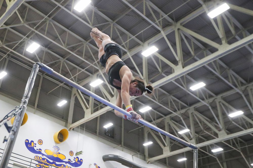 Ashley Smith performs on the uneven bars during the Iowa women’s gymnastics Black and Gold Intraquad Meet on Saturday, December 7, 2019 at the UI Field House. (Lily Smith/hawkeyesports.com)