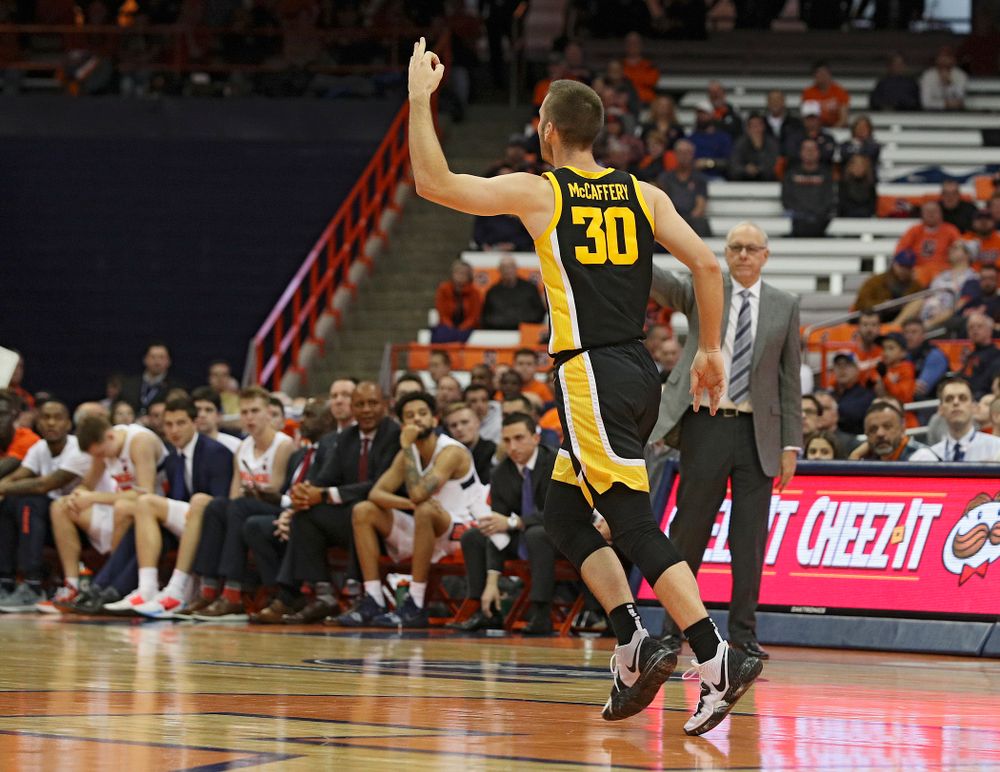 Iowa Hawkeyes guard Connor McCaffery (30) holds up three fingers after making a 3-pointer during the second half of their ACC/Big Ten Challenge game at the Carrier Dome in Syracuse, N.Y. on Tuesday, Dec 3, 2019. (Stephen Mally/hawkeyesports.com)