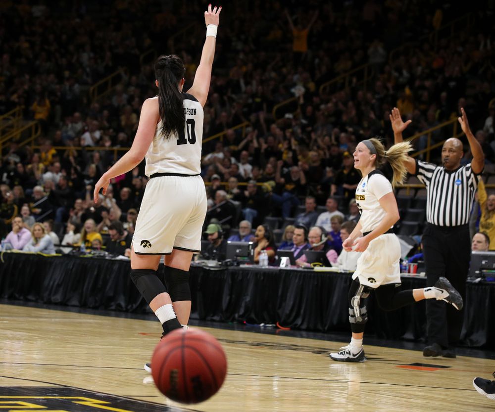 Iowa Hawkeyes forward Megan Gustafson (10) holds up three fingers after guard Makenzie Meyer (3) made a 3-pointer just before halftime during the first round of the 2019 NCAA Women's Basketball Tournament at Carver Hawkeye Arena in Iowa City on Friday, Mar. 22, 2019. (Stephen Mally for hawkeyesports.com)