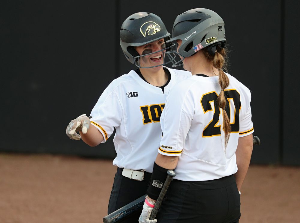 Iowa catcher Abby Lien (9) talks with designated player Miranda Schulte (20) before Schulte's at-bat during the sixth inning of their game against Ohio State at Pearl Field in Iowa City on Friday, May. 3, 2019. (Stephen Mally/hawkeyesports.com)