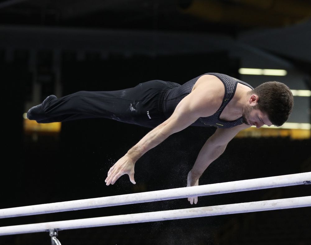 Iowa's Rogelio Vazquez competes on the parallel bars against the Ohio State Buckeyes  Saturday, March 16, 2019 at Carver-Hawkeye Arena.  (Brian Ray/hawkeyesports.com)