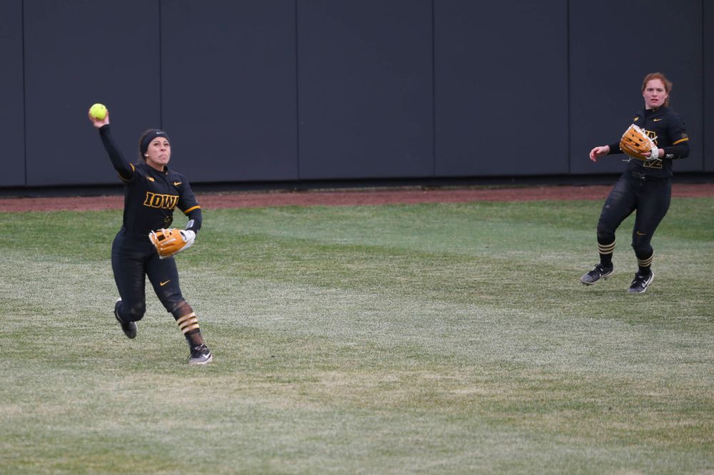 Iowa outfielder Lea Thompson (7) and Iowa's Kate Claypool (12) at game 2 vs Northwestern on Saturday, March 30, 2019 at Bob Pearl Field. (Lily Smith/hawkeyesports.com)