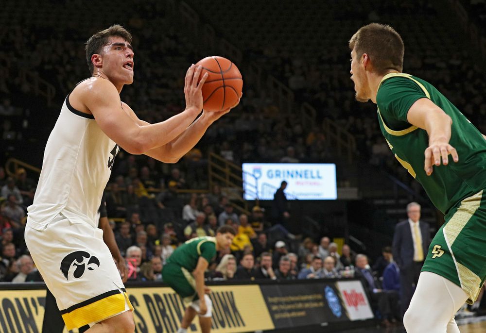 Iowa Hawkeyes center Luka Garza (55) makes a basket during the first half of their game at Carver-Hawkeye Arena in Iowa City on Sunday, Nov 24, 2019. (Stephen Mally/hawkeyesports.com)