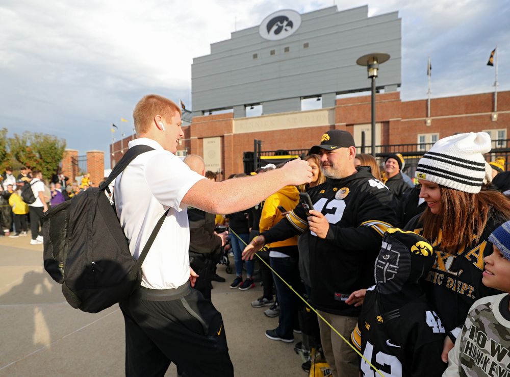 Iowa Hawkeyes tight end Shaun Beyer (42) greets fans as he arrives with his team before their game at Kinnick Stadium in Iowa City on Saturday, Oct 19, 2019. (Stephen Mally/hawkeyesports.com)
