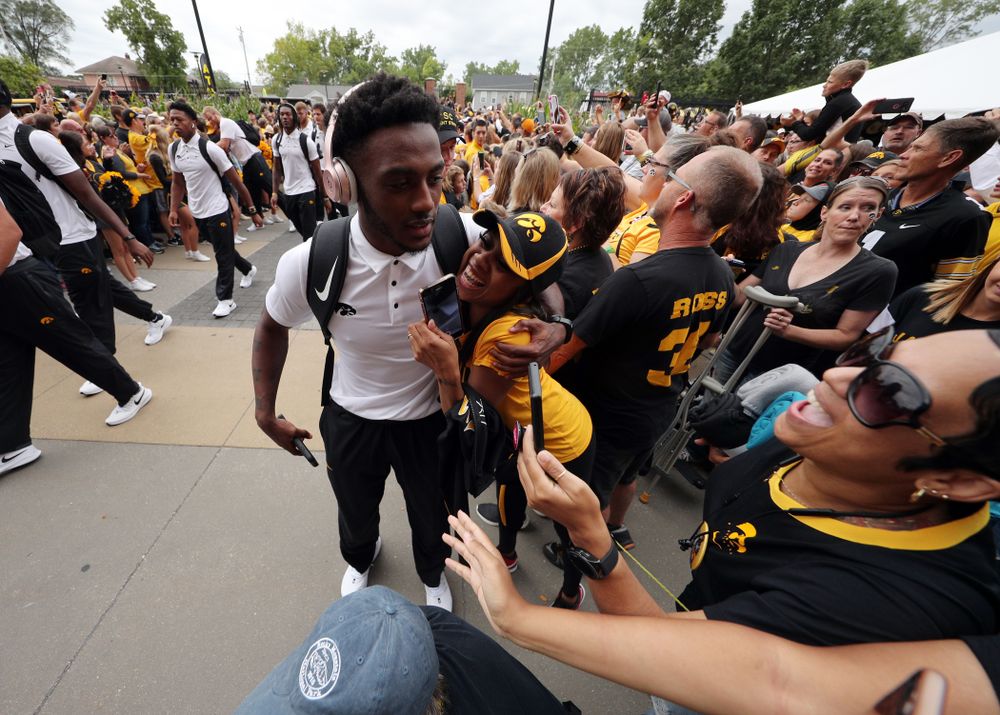 Iowa Hawkeyes defensive back Terry Roberts (16) hugs family members as the team arrives before their game against the Miami RedHawks Saturday, August 31, 2019 at Kinnick Stadium in Iowa City. (Brian Ray/hawkeyesports.com)