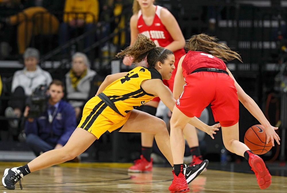 Iowa Hawkeyes guard Gabbie Marshall (24) knocks the ball away from Ohio State Buckeyes guard Jacy Sheldon (4) during the first quarter of their game at Carver-Hawkeye Arena in Iowa City on Thursday, January 23, 2020. (Stephen Mally/hawkeyesports.com)