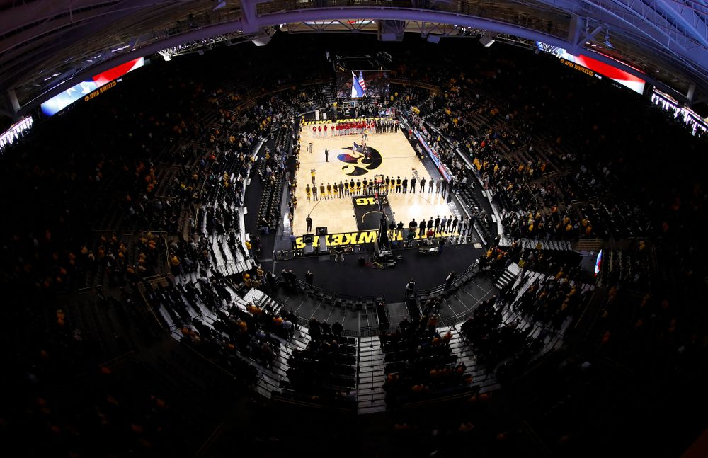The Iowa Hawkeyes stand for the National Anthem before their game 