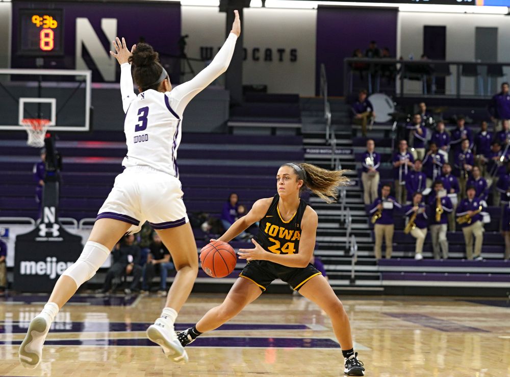 Iowa Hawkeyes guard Gabbie Marshall (24) jukes Northwestern Wildcats guard Sydney Wood (3) during the second quarter of their game at Welsh-Ryan Arena in Evanston, Ill. on Sunday, January 5, 2020. (Stephen Mally/hawkeyesports.com)