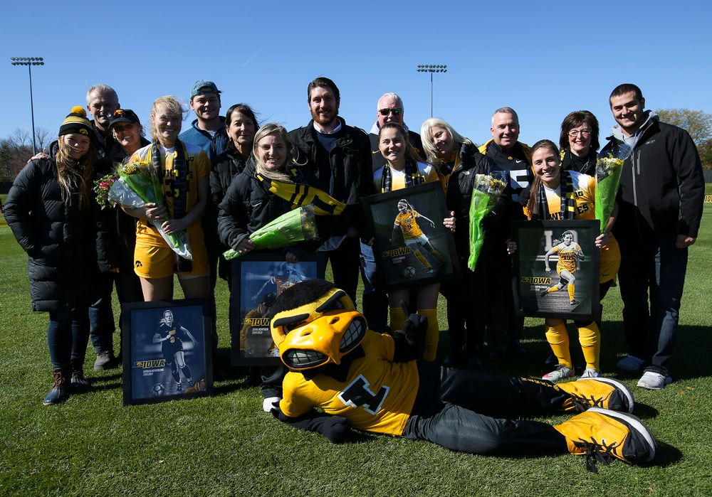 Senior members of the Iowa Hawkeyes soccer team pose for a photo with their families and Herky the Hawk during Senior Day ceremonies before a game against Northwestern at the Iowa Soccer Complex on October 21, 2018. (Tork Mason/hawkeyesports.com)