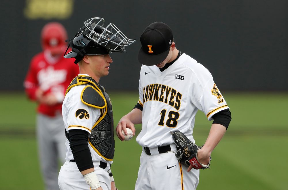 Iowa Hawkeyes catcher Tyler Cropley (5) and pitcher Shane Ritter (18) during a double header against the Indiana Hoosiers Friday, March 23, 2018 at Duane Banks Field. (Brian Ray/hawkeyesports.com)