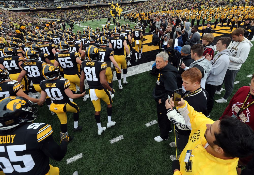 Iowa Hawkeyes head coach Kirk Ferentz watches as his team swarms the field for their game against the Purdue Boilermakers Saturday, October 19, 2019 at Kinnick Stadium. (Brian Ray/hawkeyesports.com)
