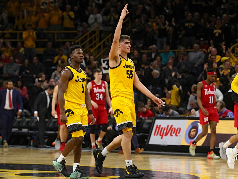 Iowa Hawkeyes center Luka Garza (55) holds up three fingers after guard CJ Fredrick (not pictured) made a 3-pointer to close out the first half of their game at Carver-Hawkeye Arena in Iowa City on Saturday, February 8, 2020. (Stephen Mally/hawkeyesports.com)