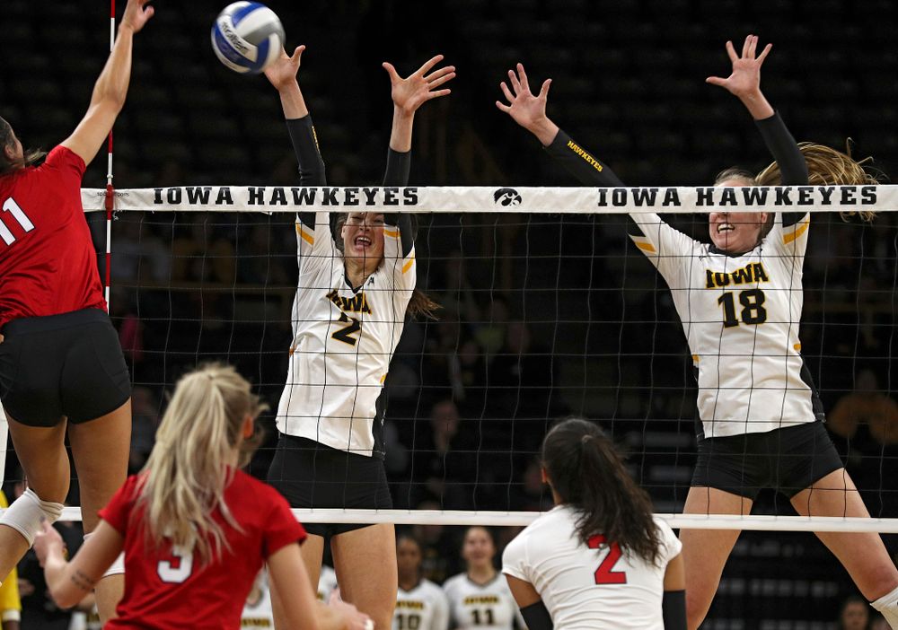 Iowa’s Courtney Buzzerio (2) tries for a block as Hannah Clayton (18) looks on during the first set of their match against Nebraska at Carver-Hawkeye Arena in Iowa City on Saturday, Nov 9, 2019. (Stephen Mally/hawkeyesports.com)