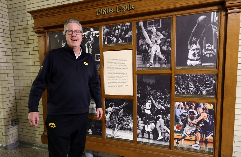 Iowa Hawkeyes head coach Fran McCaffery stands by a display with his photo in it before practice at the Palestra Friday, January 3, 2020 in Philadelphia. (Brian Ray/hawkeyesports.com)
