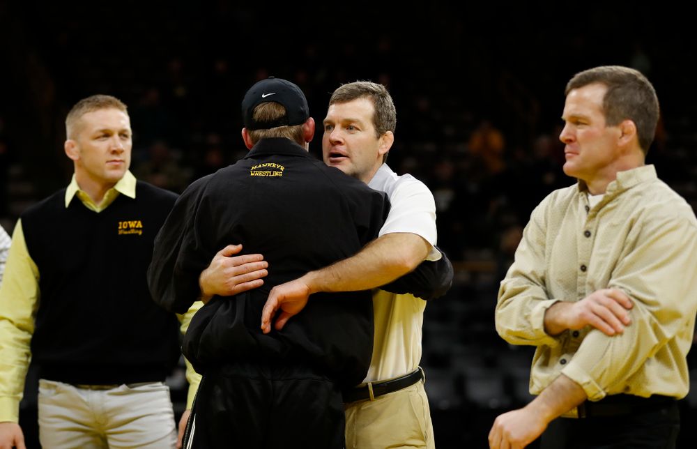 Iowa's senior Brandon Sorensen hugs head coach Tom Brands following their meet against Northwestern 