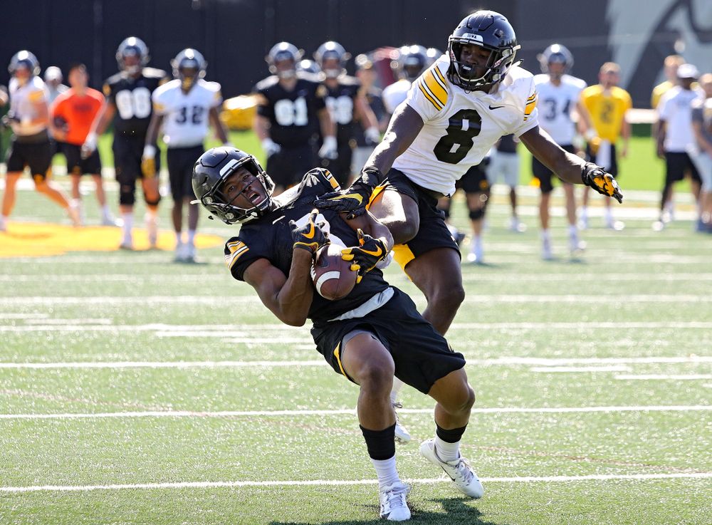 Iowa Hawkeyes wide receiver Tyrone Tracy Jr. (3) gathers in a pass around defensive back Matt Hankins (8) during Fall Camp Practice No. 13 at the Hansen Football Performance Center in Iowa City on Friday, Aug 16, 2019. (Stephen Mally/hawkeyesports.com)