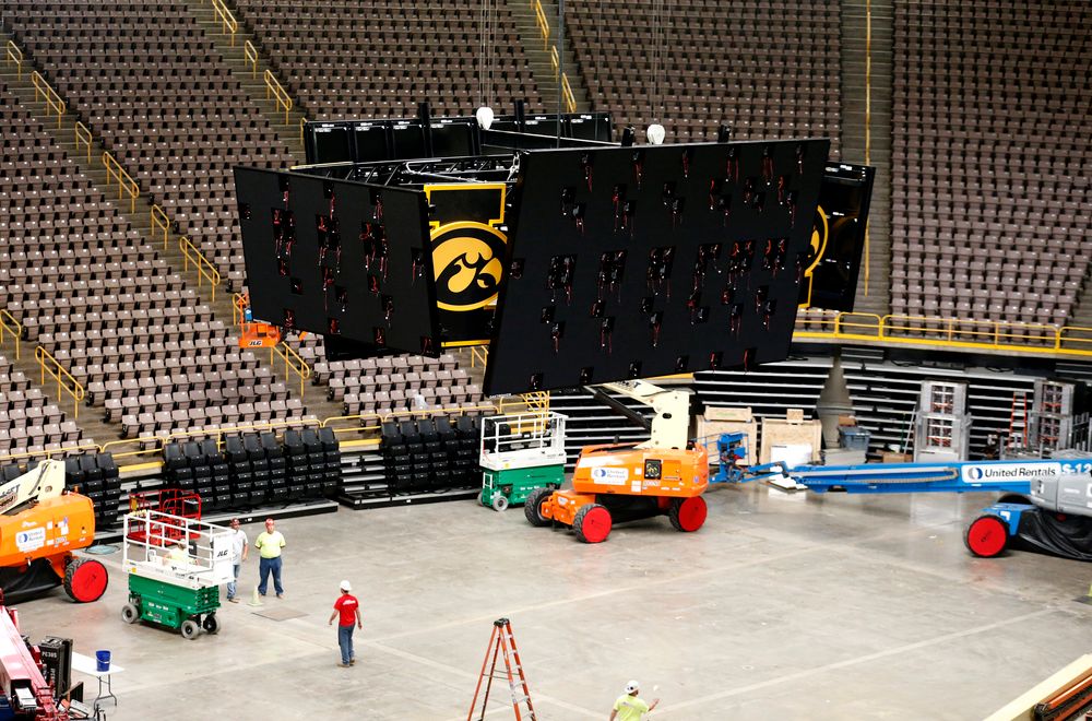 Workers raise the new centerhung video board